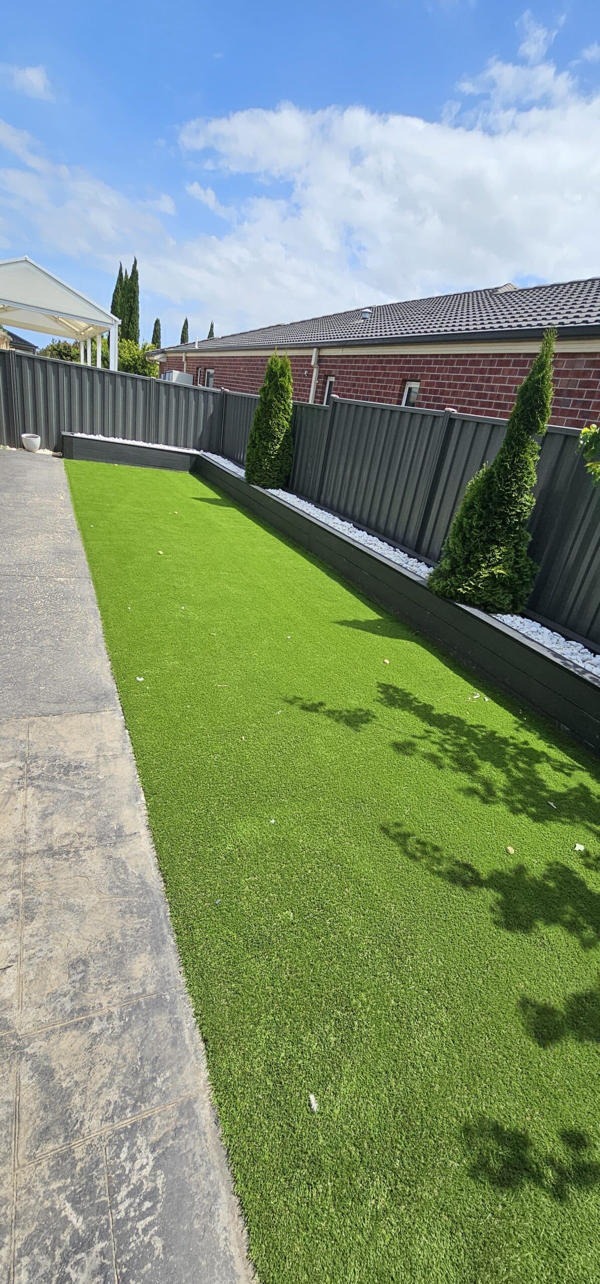 Synthetic turf, Colorbond fencing and concrete path installed by K&M Gardening